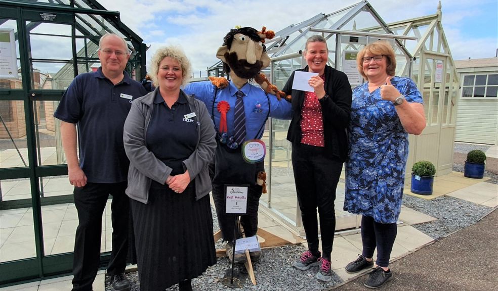 Mark Abbot and Sarah Fletcher from Otter Garden Centres with competition winner Laura Gaiger and Gayle McGoldrick from Sense Group of people with a competition winning scarecrow