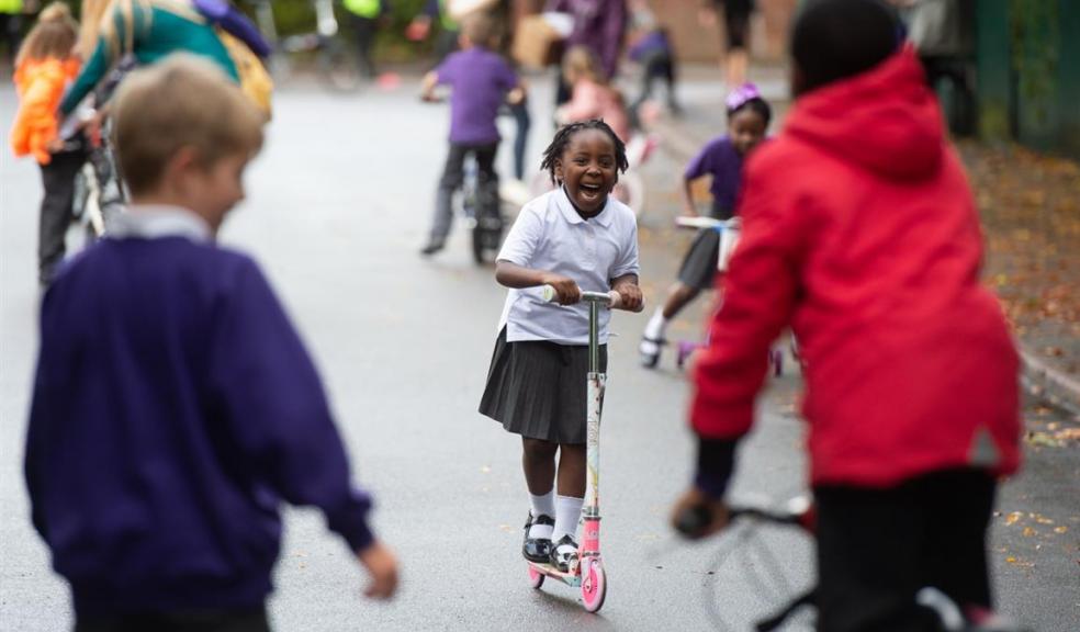Sustrans encourages families to embrace an active school run. Photo credit: ©2019, Mark Radford, all rights reserved Photo of children playing on scooters and bikes