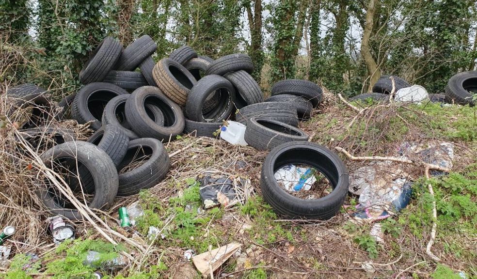 A photo of a fly-tip in East Devon with a pile of tyres