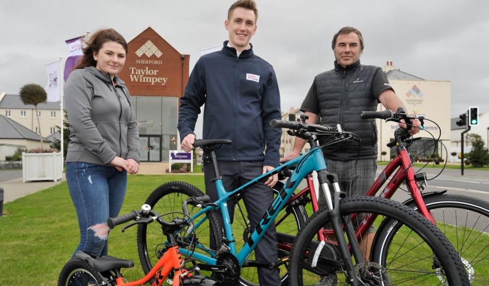 Craig and Ayesha Sheffield of The Bike Cellar with Taylor Wimpey Sales Executive Josh Keith