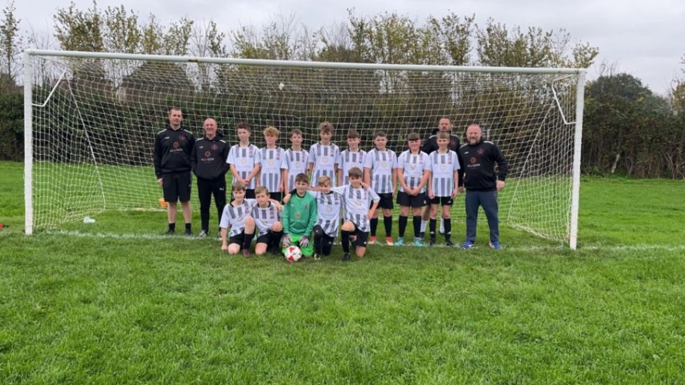 Culm Sampford Football Club players. young footballers in front of goal post on football field in Devon