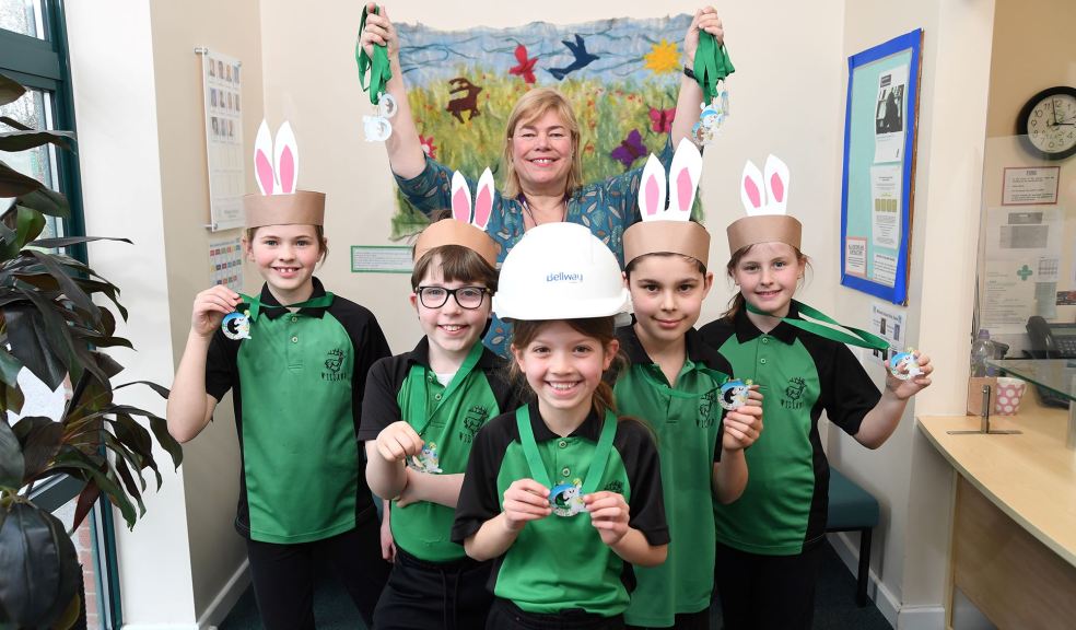 Anne Hawkins, headteacher of Willand School, and pupils with the Easter medals donated by Bellway. Anne Hawkins, headteacher of Willand School, and pupils with the Easter medals donated by Bellway.