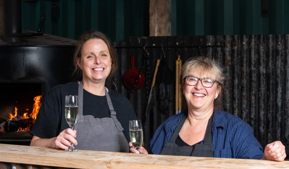 Two women enjoying a glass of fizz