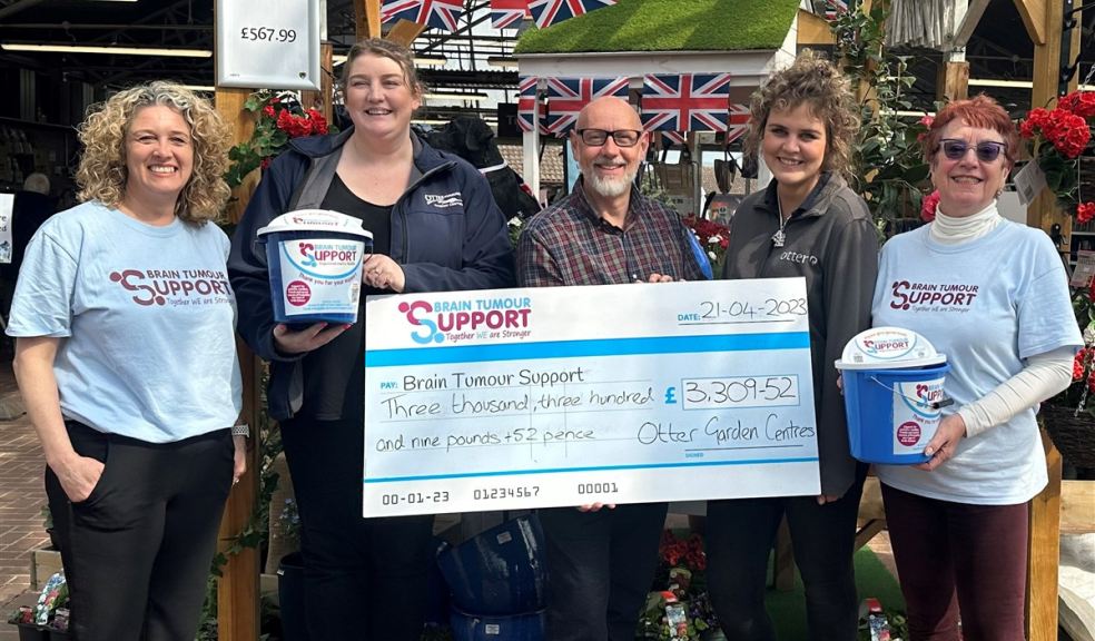 People holding a  giant cheque for Brain Tumour Support