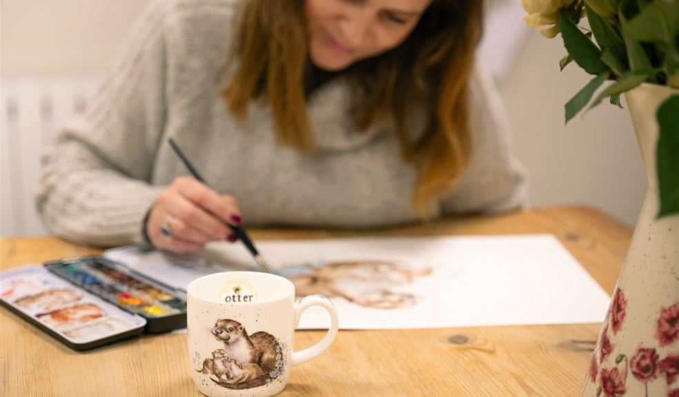 Hannah Dale working on her design for Otter Garden Centres Designer working on artwork for celebratory mug