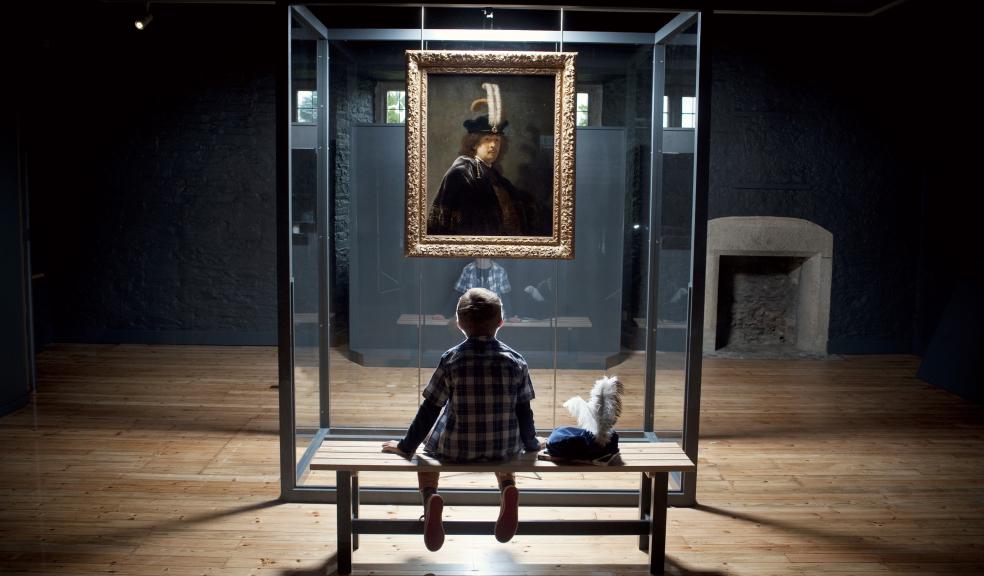 Harry Dempster and the Rembrandt painting. Credit: National Trust / Steven Haywood.