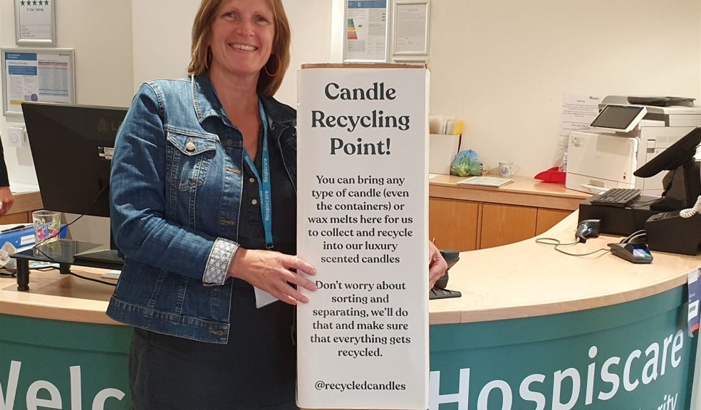 Woman standing in Hospiscare reception with candle collection point