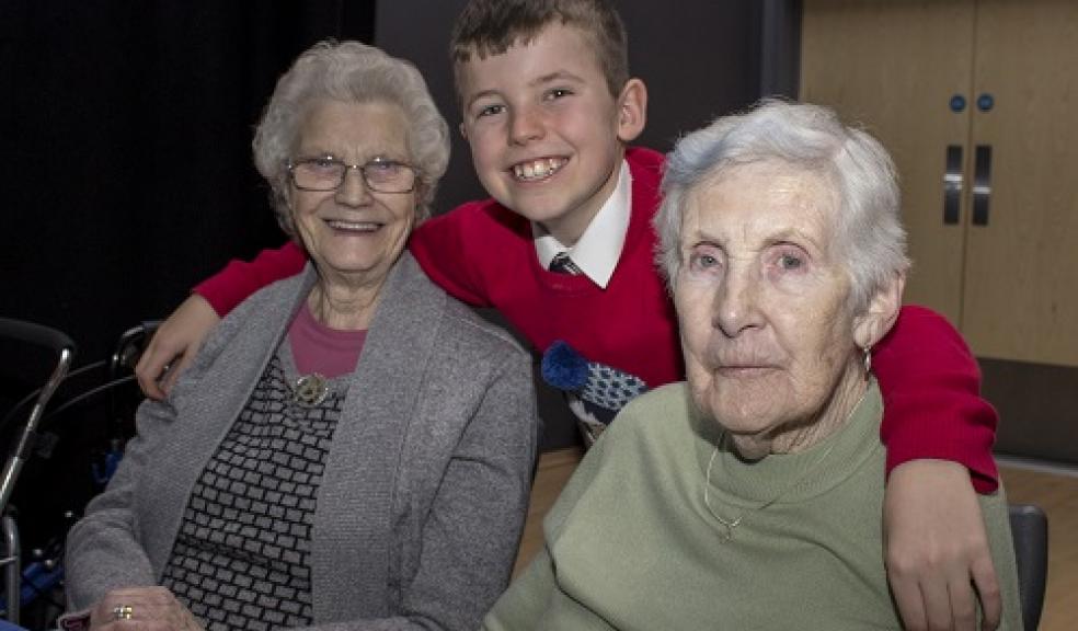 Samuel Blair with two residents from a local care home enjoying the community tea part