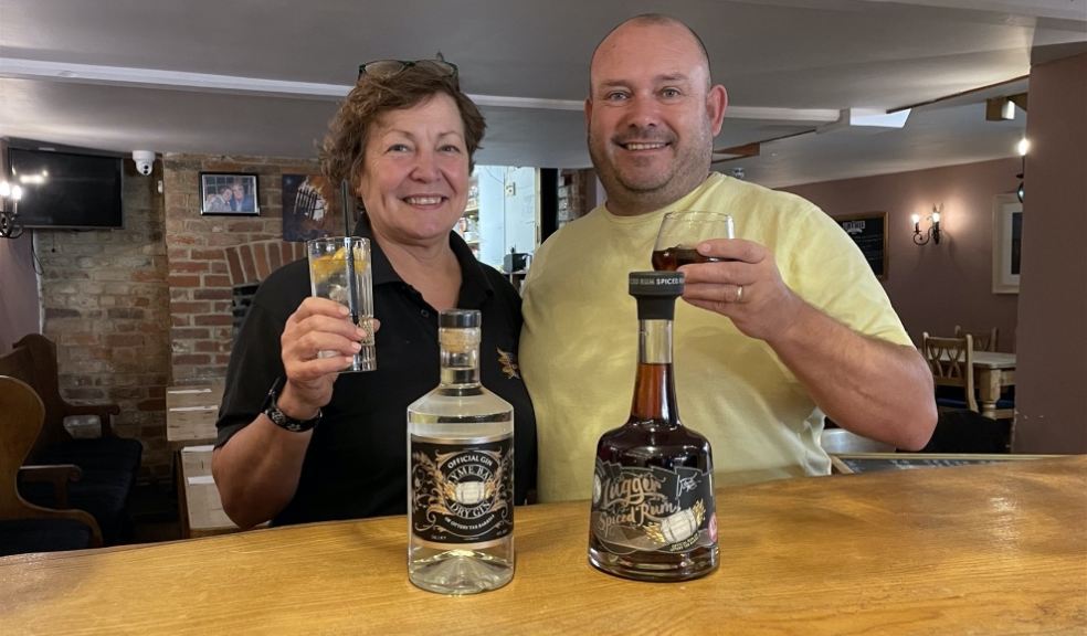 man and woman tasting a bottle of gin