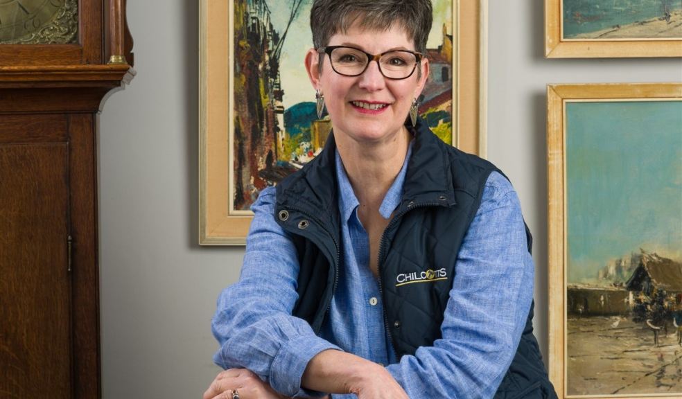 Woman in front of paintings and grandfather clock