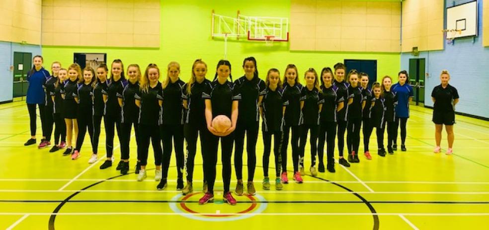 Photo caption: Plympton Academy netball players from left to right: Adelle Rogers, Laura Redman, Natalie Grace, Lily Davidson, Rianna Sleeman, Maddie Davies, Charlotte Edwards, Rachael Easterbrook, Evie Saunders, Charlotte Jones, Megan Appleby, Ella Kerswill (centre of pic), Leah Nelson, Millie Simon, Mya Visick, Abi White, Lucy Packer, Brooke Macqueen, Eleanor Foot, Summer Holmes, Sophie Hitchcock, Jasmine Barton, Lacey Searle and PE teacher, Miss Kirsty Luke.