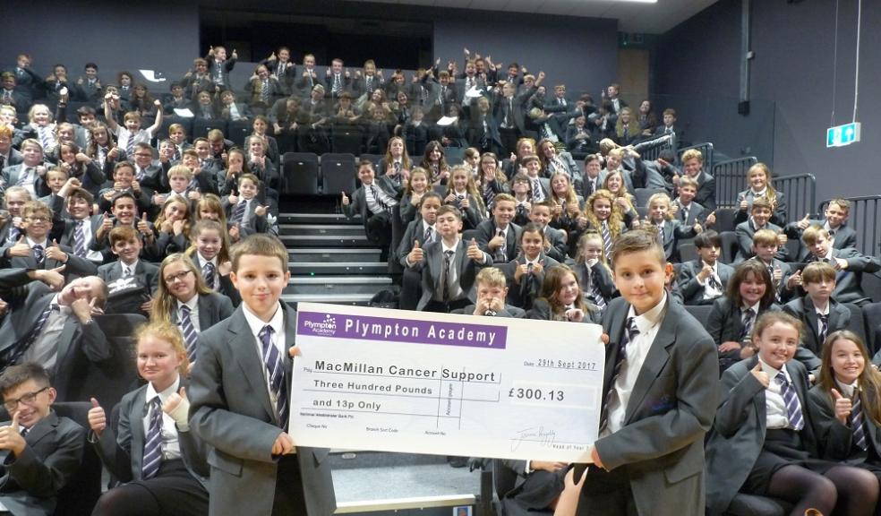 Photo caption: Harley Day (right) and Calum Hodge with the cheque for Macmillan Cancer Support.