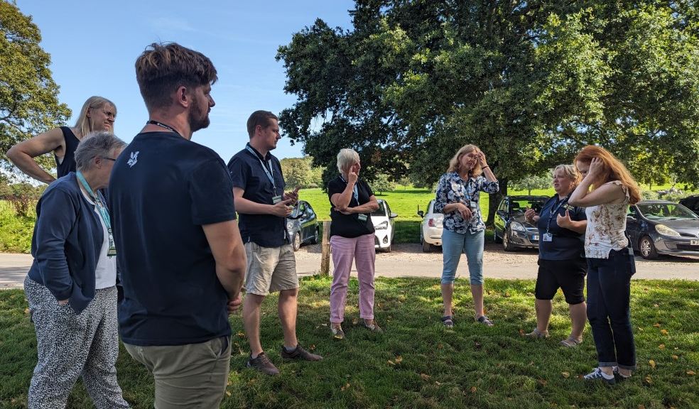 The participants outside at Saltram A group of people stand outside at Saltram listening to the instructor