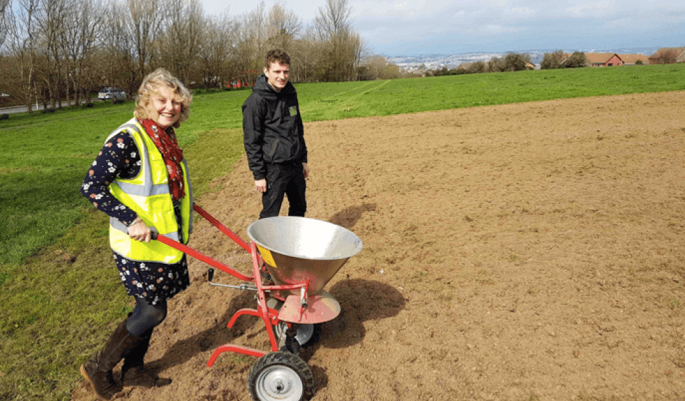 Councillor Sue Dann helps to seed the new wildflower meadow at Staddiscombe with Kieran Shaw-Flach from the Council’s Natural Infrastructure team.