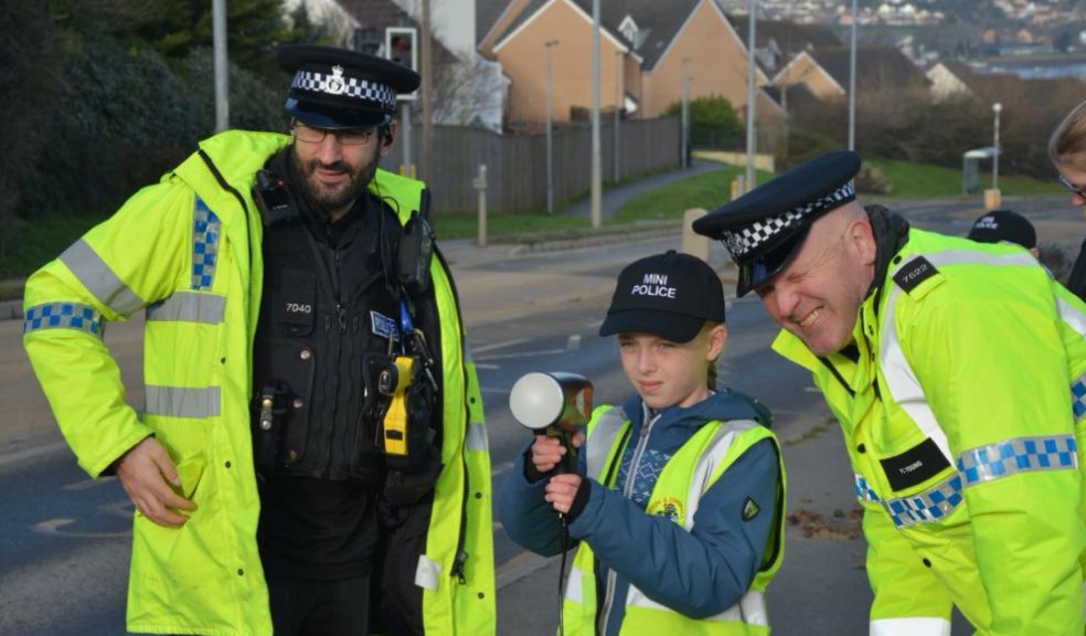 Neighbourhood Beat Manager PC Daniel Ciantar (left) with PC Matt Young on the right. The pupil is Amelie Slade from Year 5 Mantis Shrimp class at East the Water School in Bideford. Two policeman with child and traffic speed gun