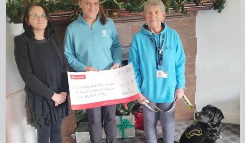 Maria Nolan and Sophie Page present the fundraising cheque to Guide Dogs volunteer Di Hatchett and guide dog puppy in training, Floss. Maria Nolan and Sophie Page present the fundraising cheque to Guide Dogs volunteer Di Hatchett and g