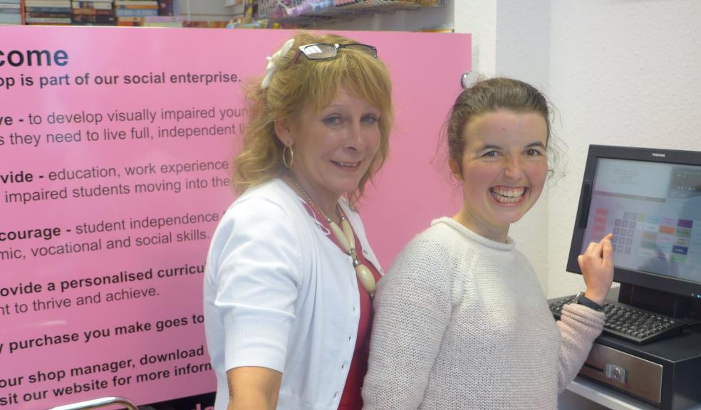 Photograph by Glen King: Sidmouth Social Enterprise Manageress Sharon Green with Ex-WESC learner, Alice Bray (23) from Newton Poppleford operating the specially adapted till, with braille overlay and colour coded buttons.