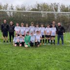 young footballers in front of goal post on football field in Devon