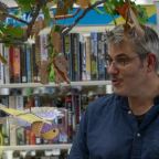James stood in front of library books