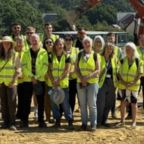 Building team stood on land in hi vis jackets