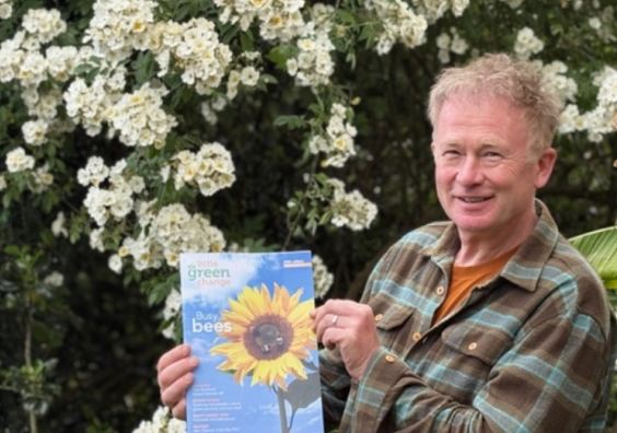 Toby Buckland holding an eco magazine