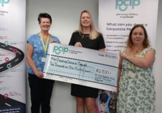 Charity members holding a cheque for PCIP