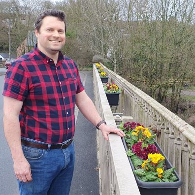 Man standing on a bridge in Ottery St Mary