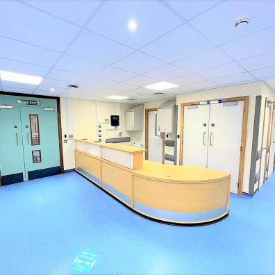 Hospital corridor with blue floor.  