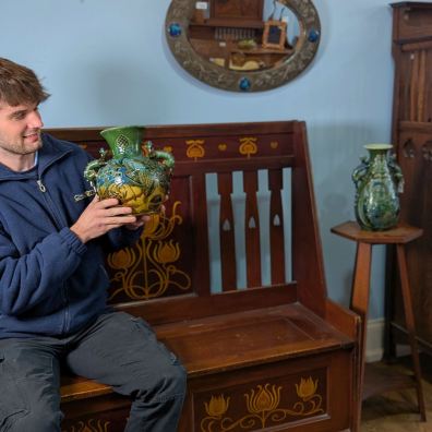 Cataloguer Barnaby Willis with examples of Brannam Pottery and Shapland and Petter furniture