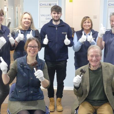 Auctioneering team wearing white gloves