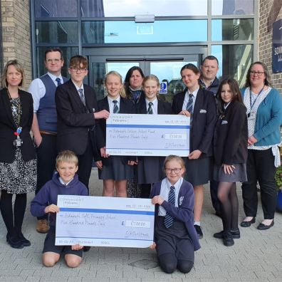 Presenting cheques to two schools