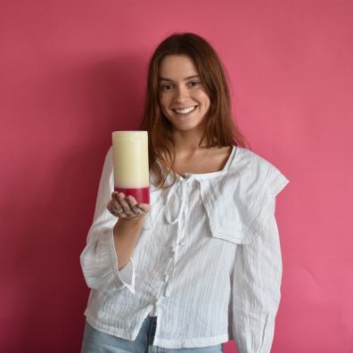 Woman holding a recycled charity candle for Missing People