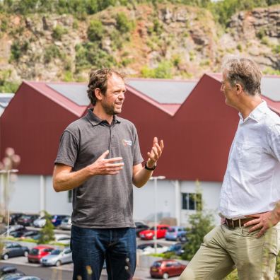 Two people discussing renewable energy at a site installation