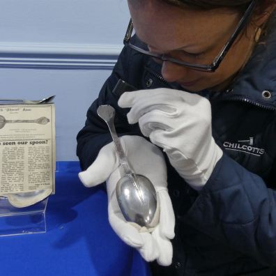 Jennifer Bell from Chilcotts examining a silver spoon