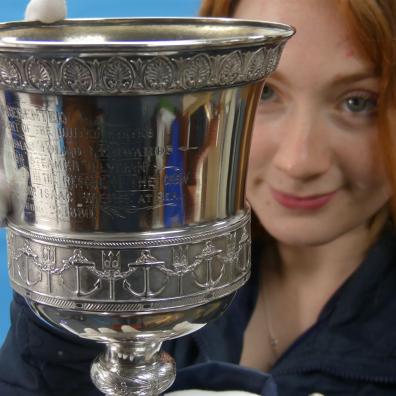 Woman looking at antique cup