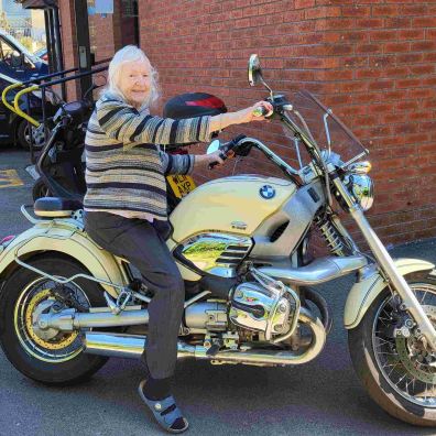 Molly Coyne on the motorbike, Butterfly Lodge