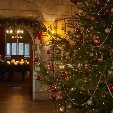 Entrance hall decorated for Christmas at Castle Drogo in Devon