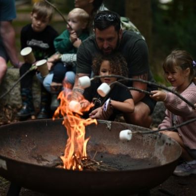 Children roasting marshmallows on a camp fire