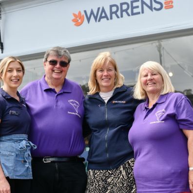 Warrens and dementia awareness people stood outside of warrens