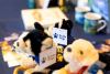 Some Guide Dogs fluffy soft toys on a merchandise stand. 