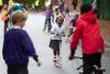 Photo of children playing on scooters and bikes