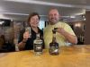 man and woman tasting a bottle of gin